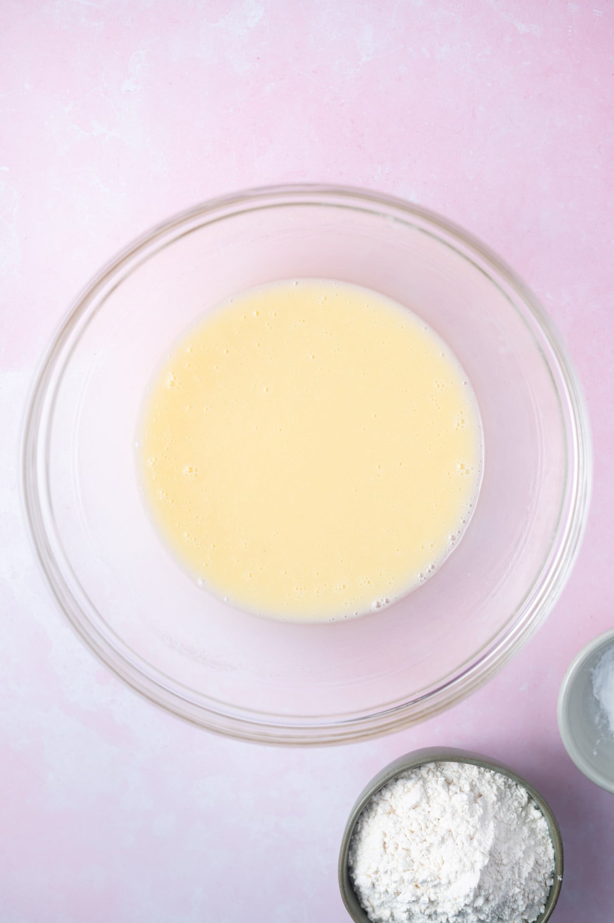 extracts and oil added to cake batter in a bowl
