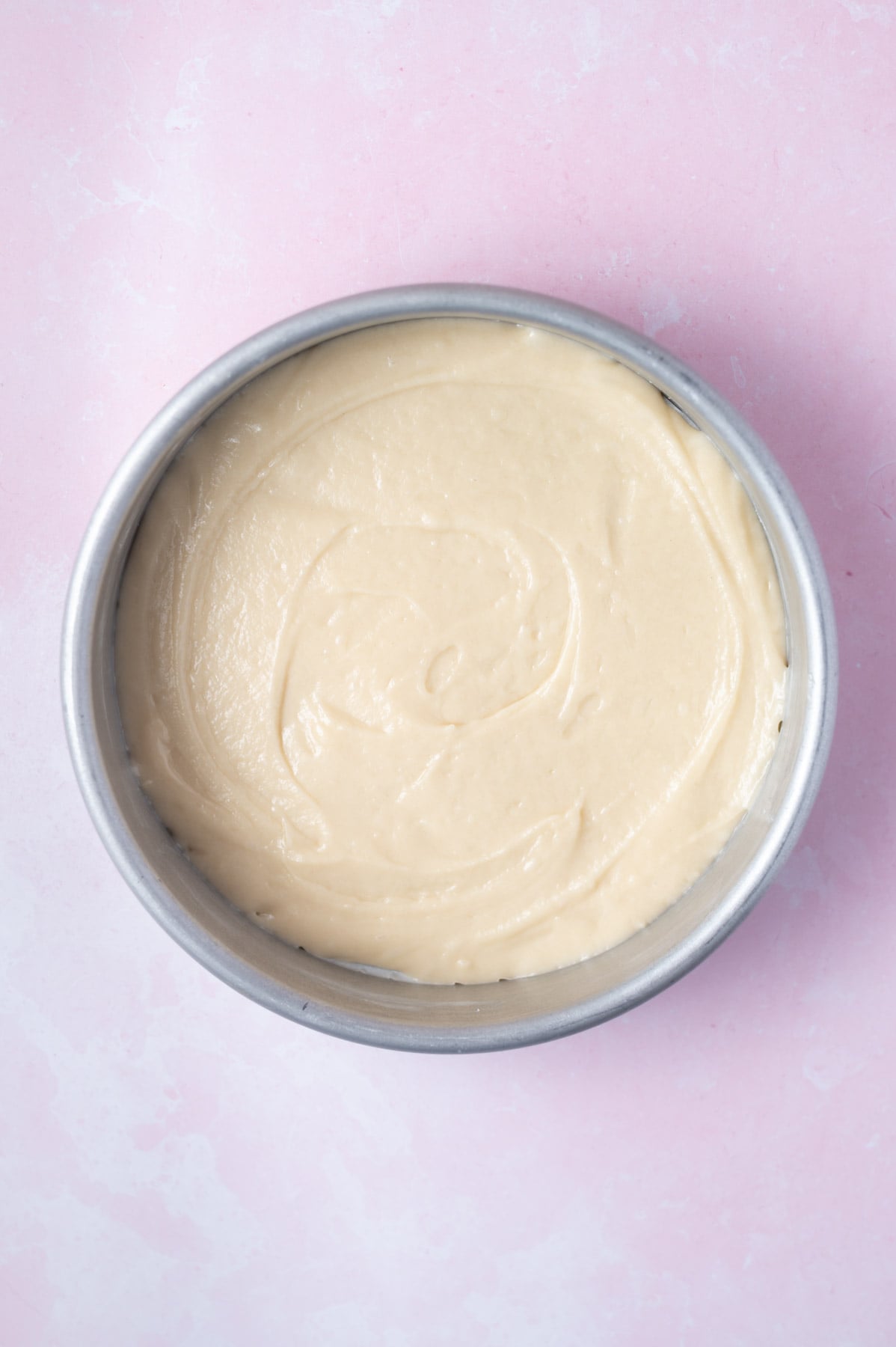 half of cake batter spread into the bottom of a 8-inch round baking pan