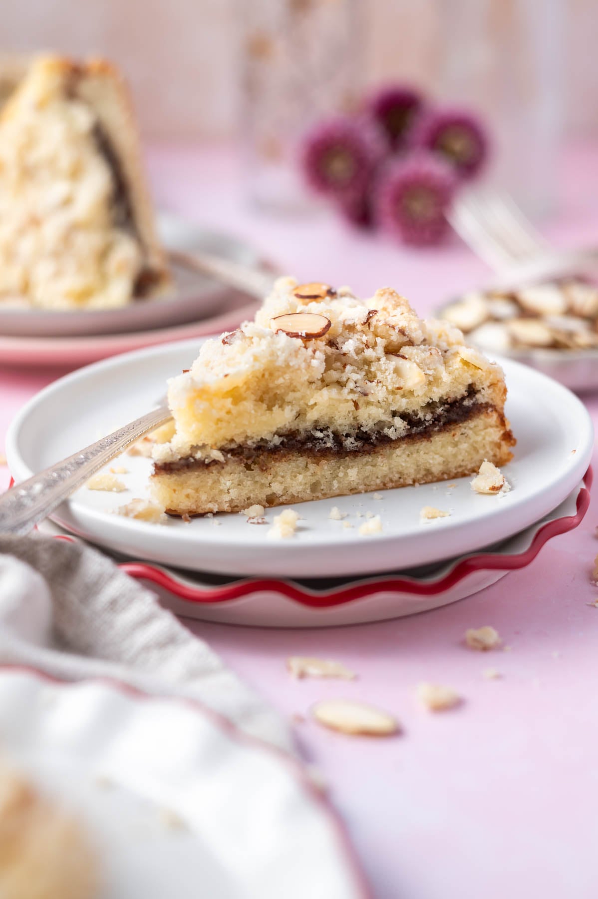 slice of almond coffee cake on a plate showing almond paste filling