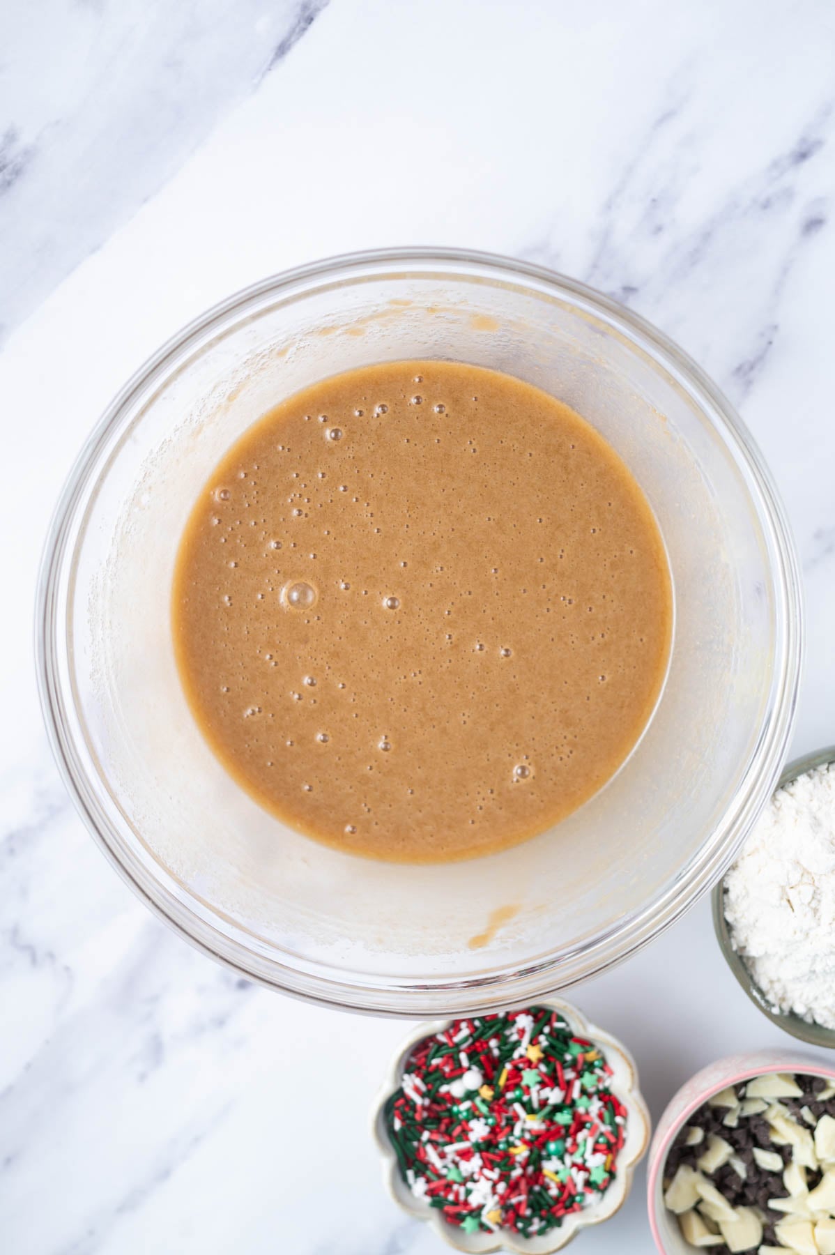 eggs and vanilla whisked into to sugars and butter in a glass bowl