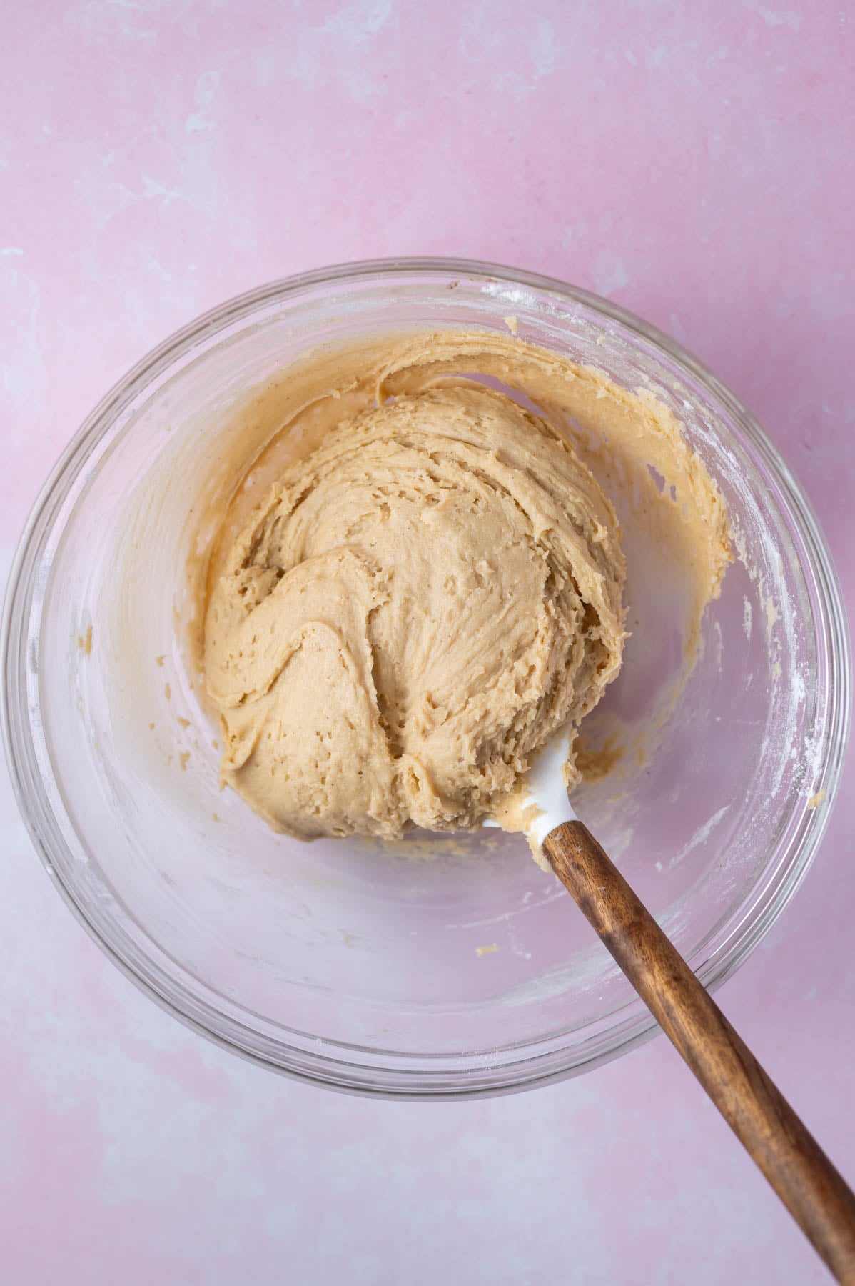 cookie dough in a glass bowl with a spatula