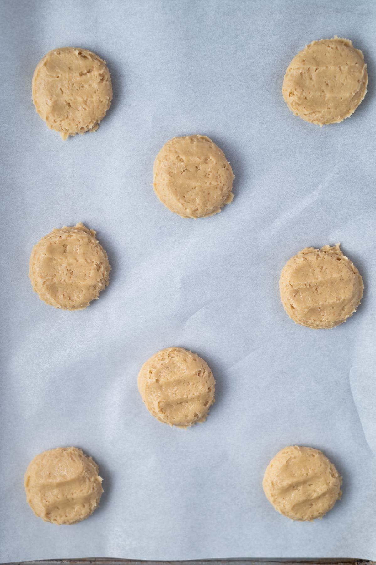 cookie dough flattened on a parchment lined pan