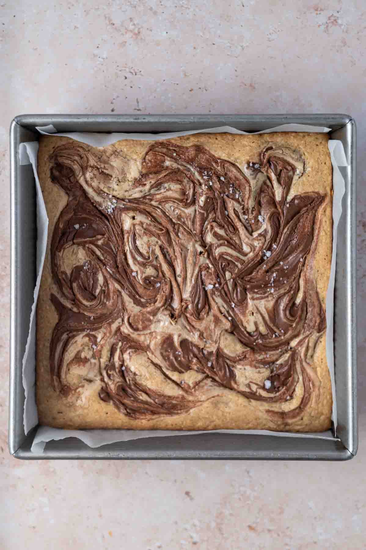 baked blondies in a parchment lined pan